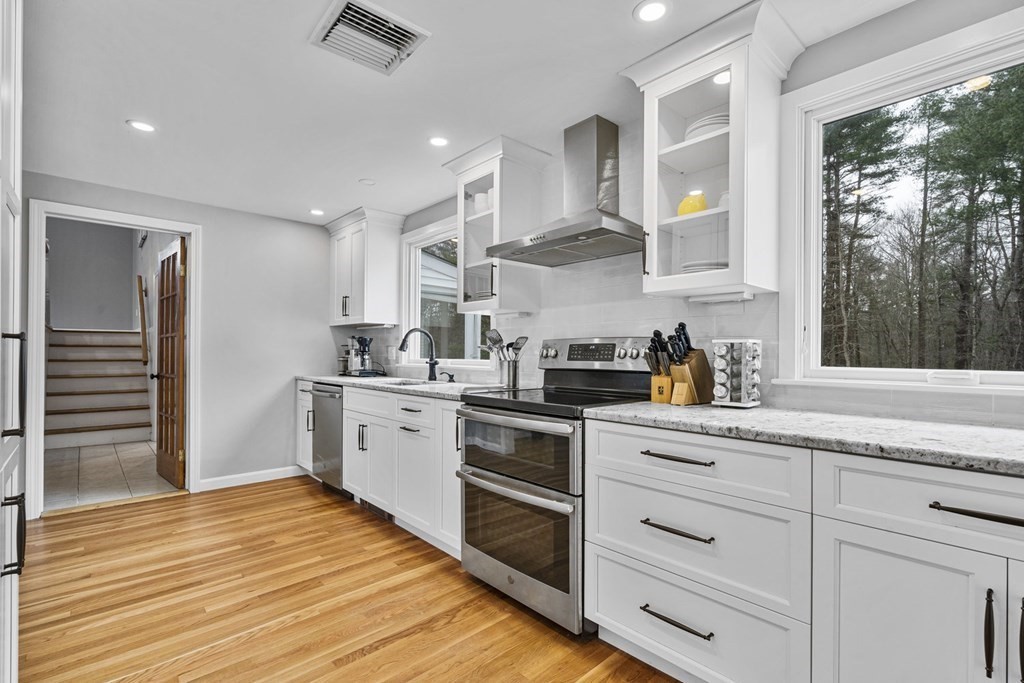 45 Lyndon Road Sharon, MA 02067 - Photo 6 of 31 a kitchen with granite countertop white cabinets and white appliances
