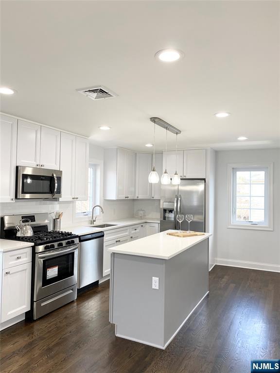 61 Chestnut Street, Unit 2 Lodi, NJ 07644 - Photo 5 of 22 a kitchen with stainless steel appliances granite countertop a sink a stove and a refrigerator