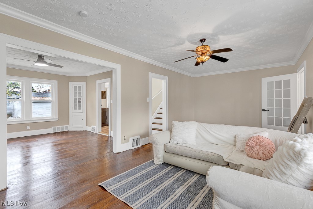 2127 Rossmoor Road Cleveland Heights, OH 44118 - Photo 7 of 21 Living area featuring wood finished floors, ceiling fan, and visible vents