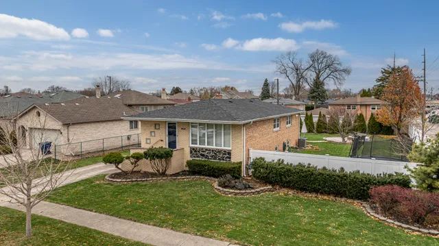 a front view of a house with garden and porch