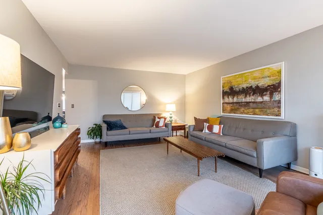 a living room with furniture a large window and a flat screen tv