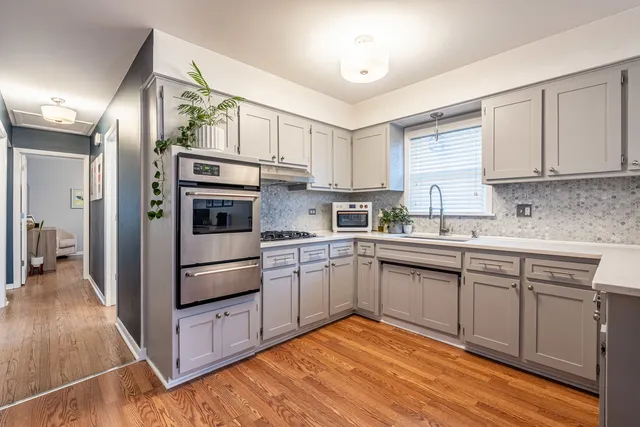 a kitchen with cabinets oven and a sink