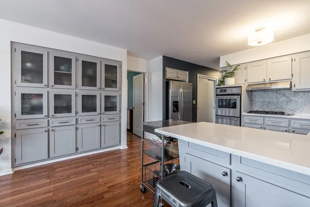 a room with furniture a air conditioner vent and a window