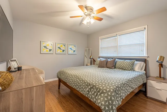 a bedroom with a bed and a chandelier