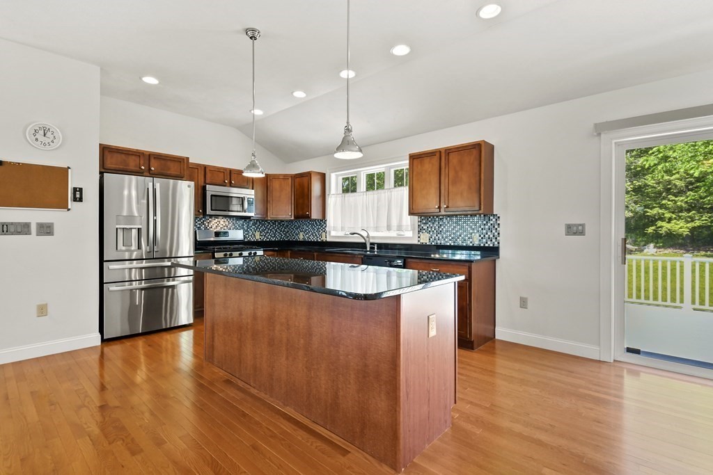 8 Hickory Way Ayer, MA 01432 - Photo 11 of 35 a kitchen with stainless steel appliances granite countertop a refrigerator a sink and a stove