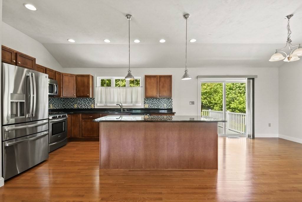8 Hickory Way Ayer, MA 01432 - Photo 13 of 35 a kitchen with stainless steel appliances granite countertop a refrigerator a oven and a wooden floors