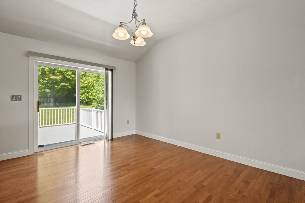 8 Hickory Way Ayer, MA 01432 - Photo 15 of 35 a view of a livingroom with wooden floor and a large window