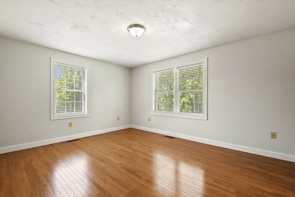 8 Hickory Way Ayer, MA 01432 - Photo 17 of 35 a view of an empty room with wooden floor and a window
