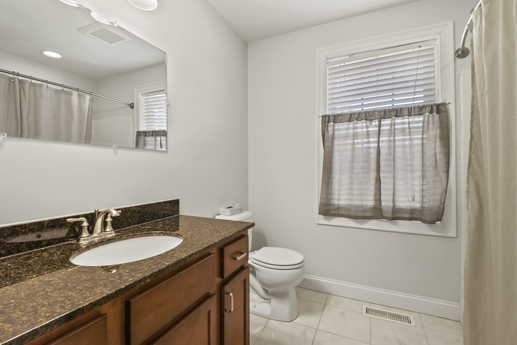 8 Hickory Way Ayer, MA 01432 - Photo 19 of 35 a bathroom with a granite countertop sink vanity mirror and toilet