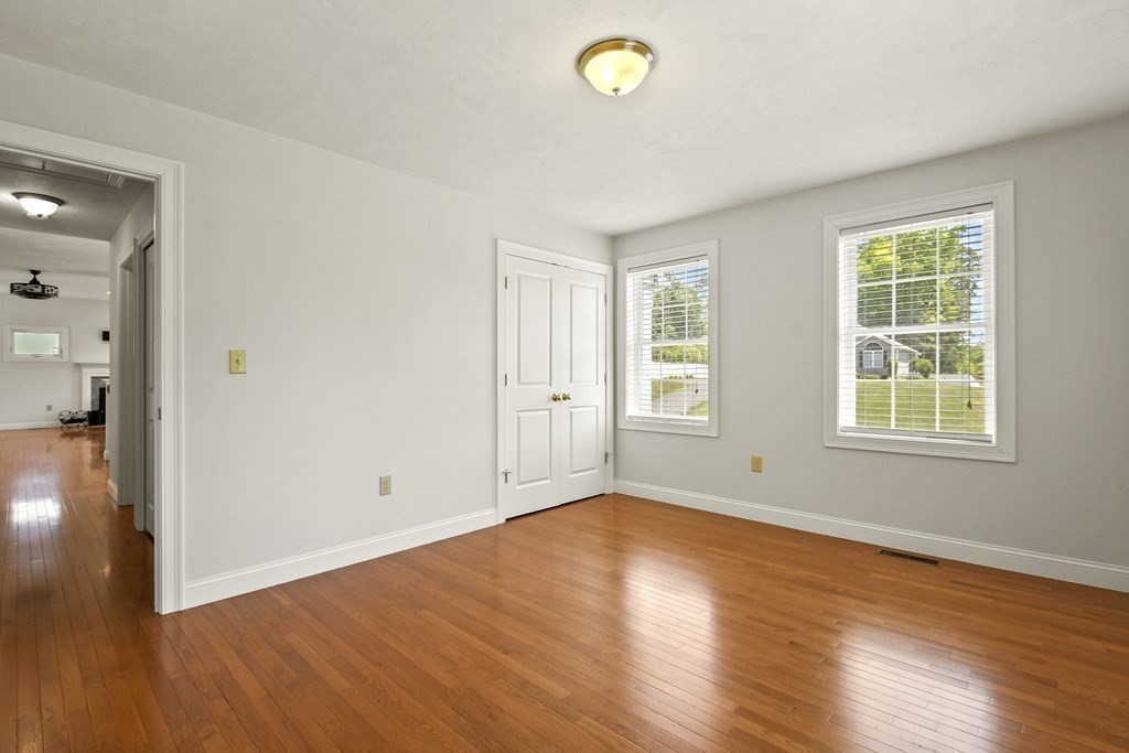8 Hickory Way Ayer, MA 01432 - Photo 21 of 35 an empty room with wooden floor and windows