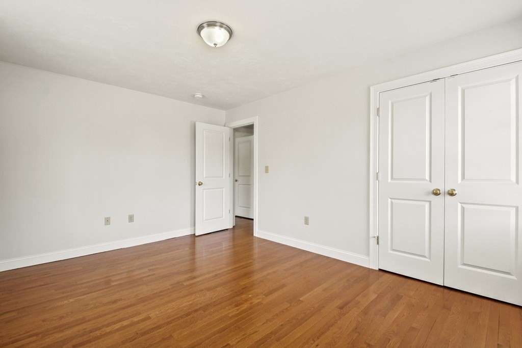 8 Hickory Way Ayer, MA 01432 - Photo 22 of 35 an empty room with wooden floor
