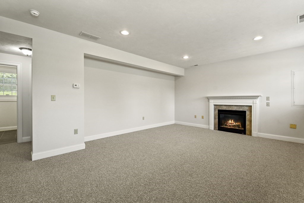 8 Hickory Way Ayer, MA 01432 - Photo 24 of 35 a view of an empty room with a fireplace