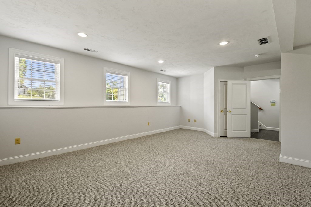 8 Hickory Way Ayer, MA 01432 - Photo 25 of 35 an empty room with a window and a bathroom