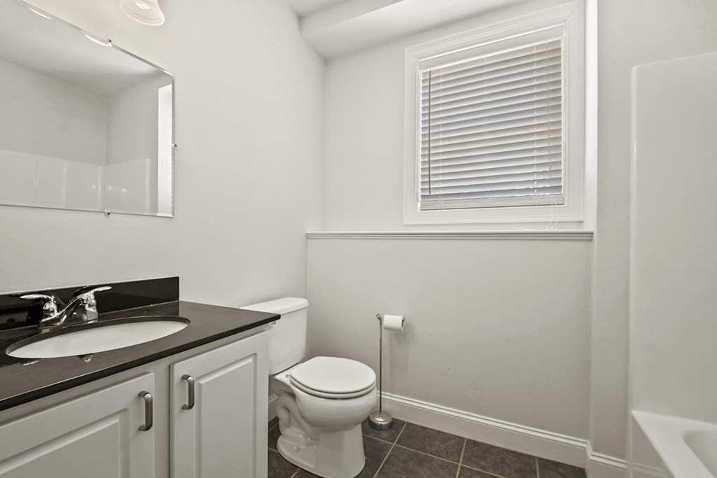 8 Hickory Way Ayer, MA 01432 - Photo 27 of 35 a bathroom with a sink a toilet and a window