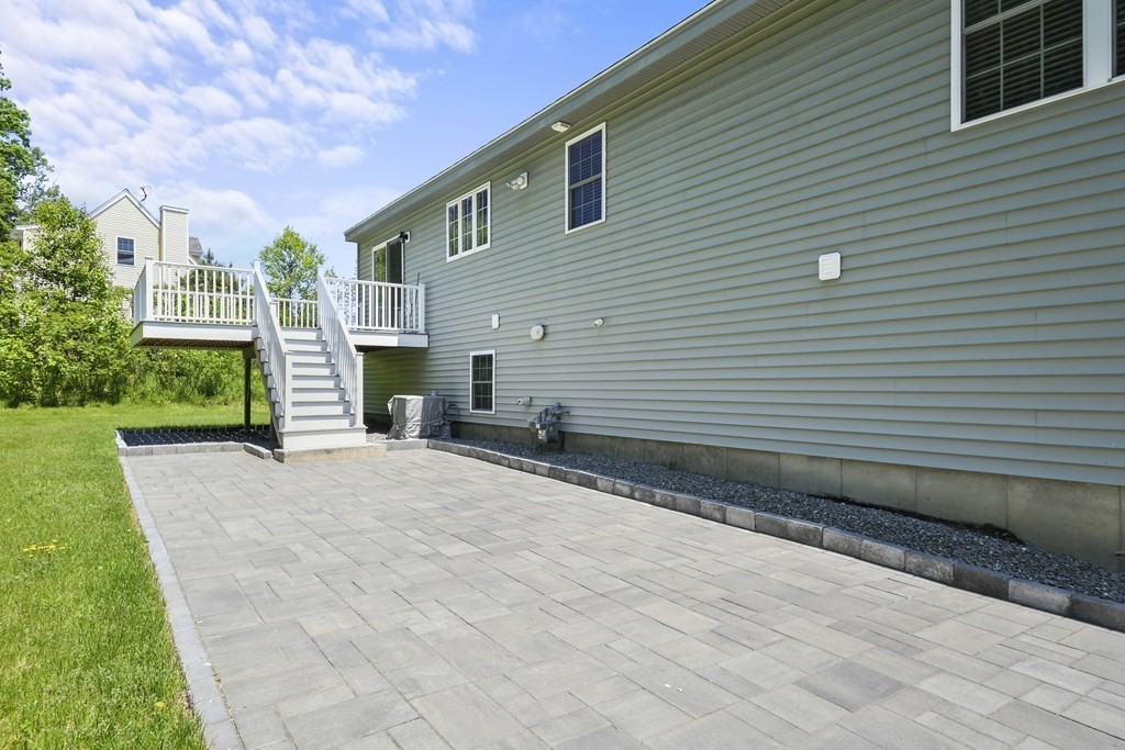 8 Hickory Way Ayer, MA 01432 - Photo 31 of 35 a front view of a house with yard and parking