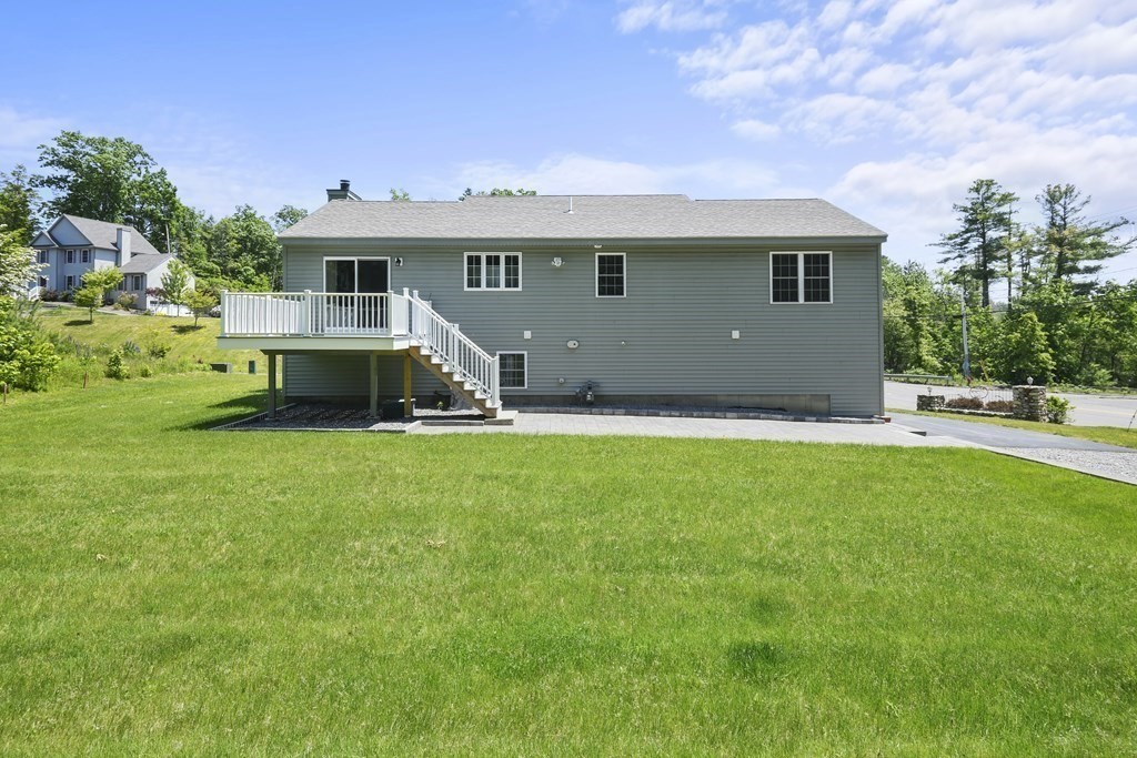 8 Hickory Way Ayer, MA 01432 - Photo 33 of 35 a front view of a house with a yard and garage