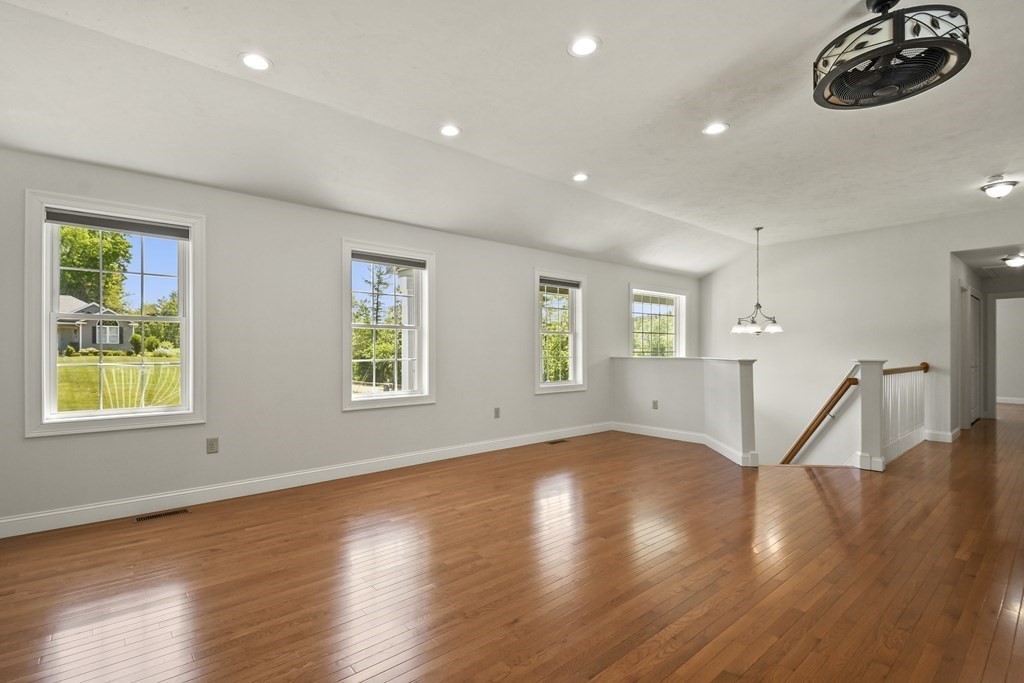8 Hickory Way Ayer, MA 01432 - Photo 7 of 35 a view of empty room with wooden floor and fan