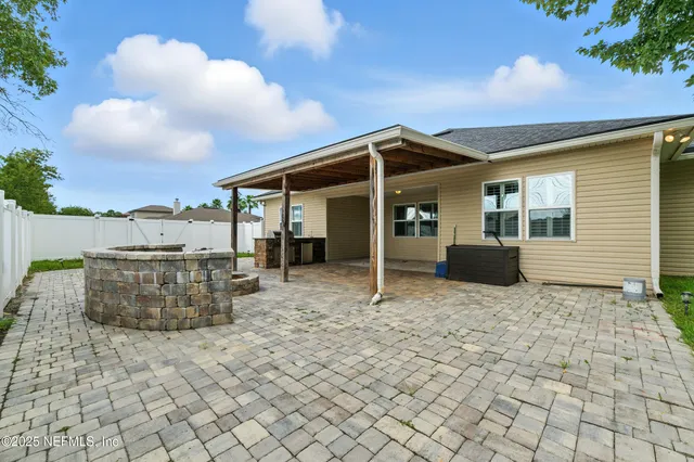 a view of a house with backyard and sitting area