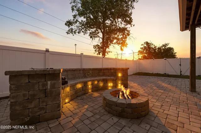 a backyard of a house with fountain and barbeque oven