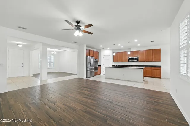 a view of kitchen with wooden floor and window