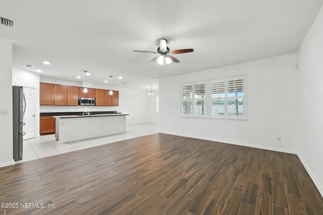 a view of kitchen with granite countertop cabinets stainless steel appliances and a fireplace