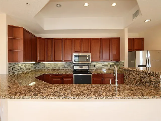 a kitchen with a stove a sink and a microwave