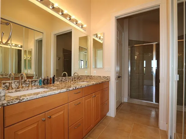 a bathroom with a double vanity sink and mirror