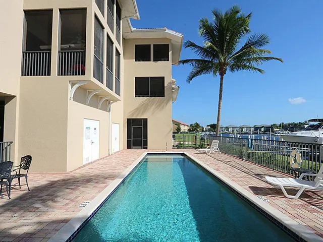 a view of swimming pool with a lounge chairs