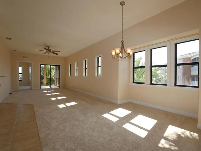 a view of hallway with window and chandelier