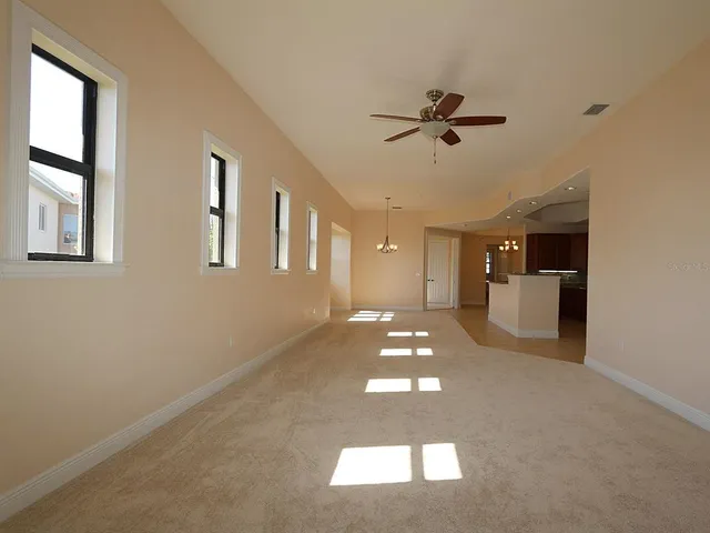 a view of a livingroom with a ceiling fan and window