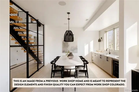 a spacious bedroom with a bed a mirror and a large window