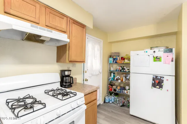 a white refrigerator freezer sitting inside of a kitchen