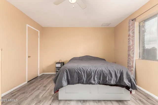 a bed sitting in a bedroom next to a window