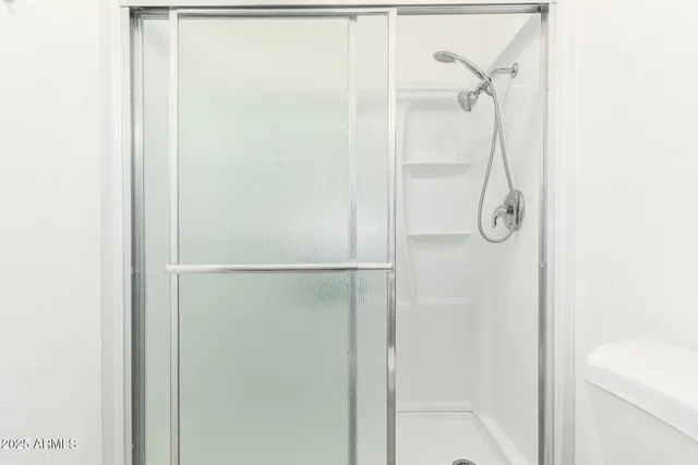 a bathroom with a glass shower door