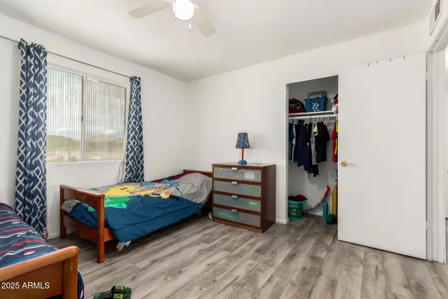 a bedroom with a bed and a window