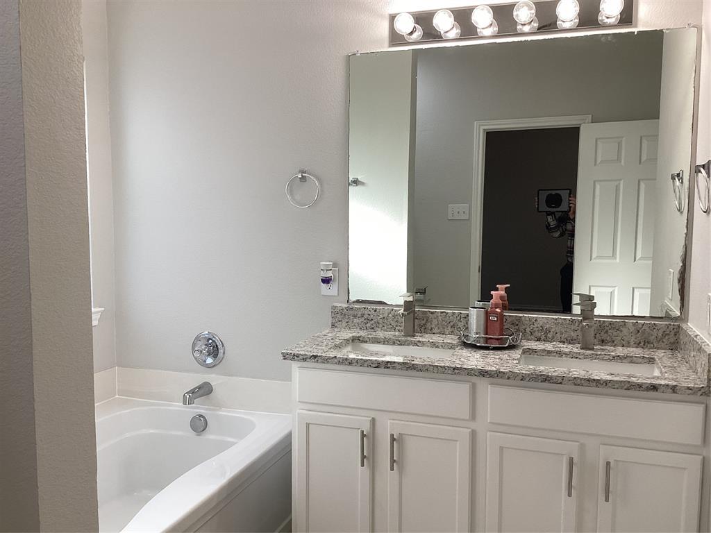 4608 Wolf Ridge Way Fort Worth, TX 76244 - Photo 13 of 23 a bathroom with a granite countertop sink and a mirror