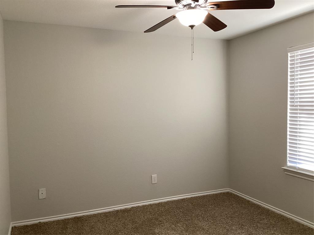 4608 Wolf Ridge Way Fort Worth, TX 76244 - Photo 18 of 23 an empty room with a window and a ceiling fan