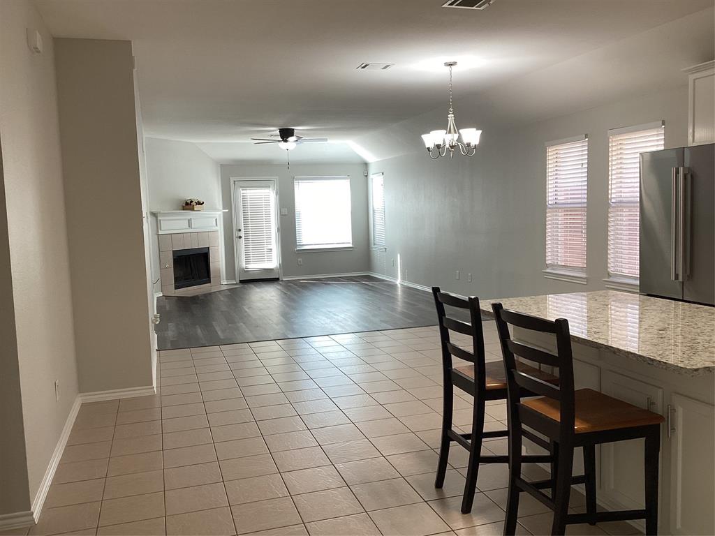 4608 Wolf Ridge Way Fort Worth, TX 76244 - Photo 2 of 23 an empty room with chandelier fan and windows