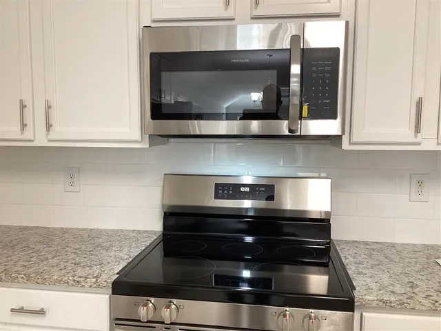 a kitchen with a stove and a microwave