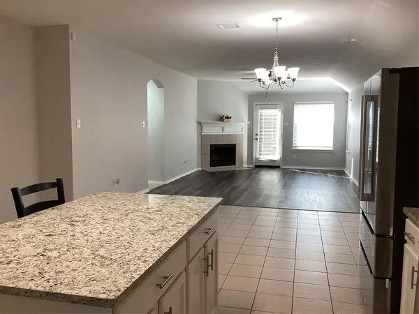 a view of a kitchen with granite countertop natural light