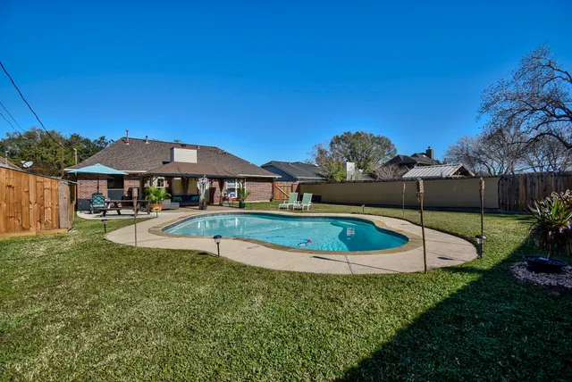 a view of a house with a yard and sitting area