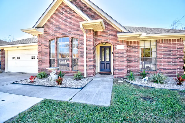 a front view of a house with a garden