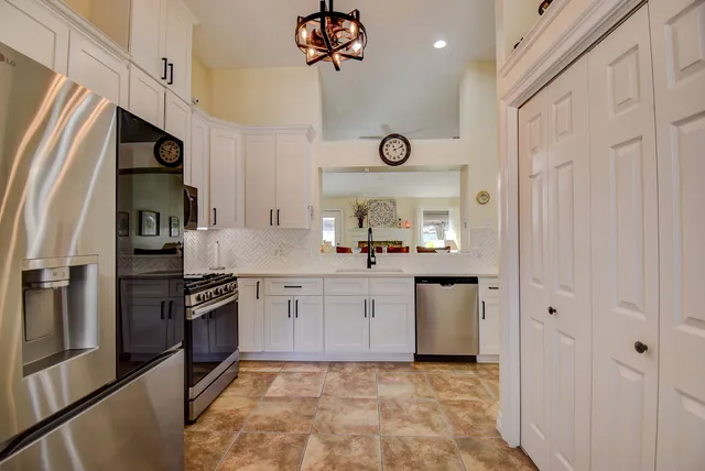 a kitchen with a refrigerator sink and stove