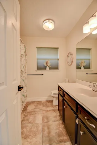 a spacious bathroom with a sink a mirror and a shower