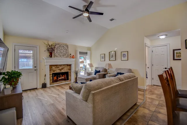 a living room with furniture and a fireplace