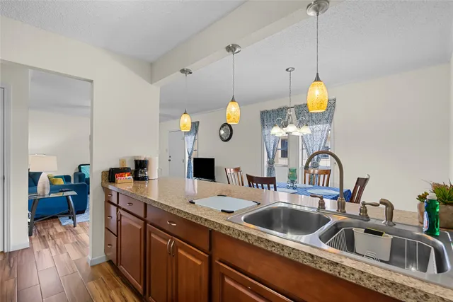a kitchen with a sink a counter space and stainless steel appliances