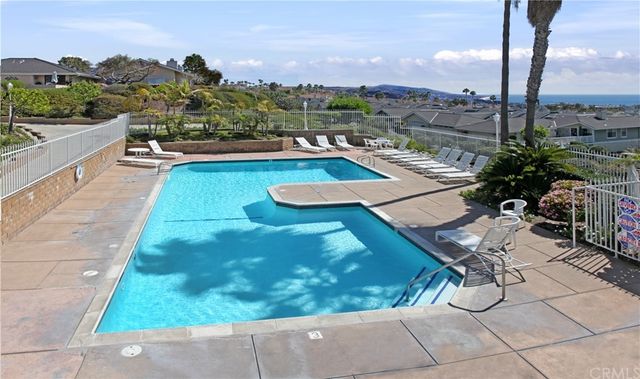 a view of swimming pool with a lounge chairs