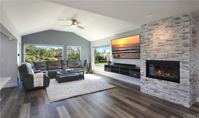 a living room with furniture flat screen tv and a fireplace