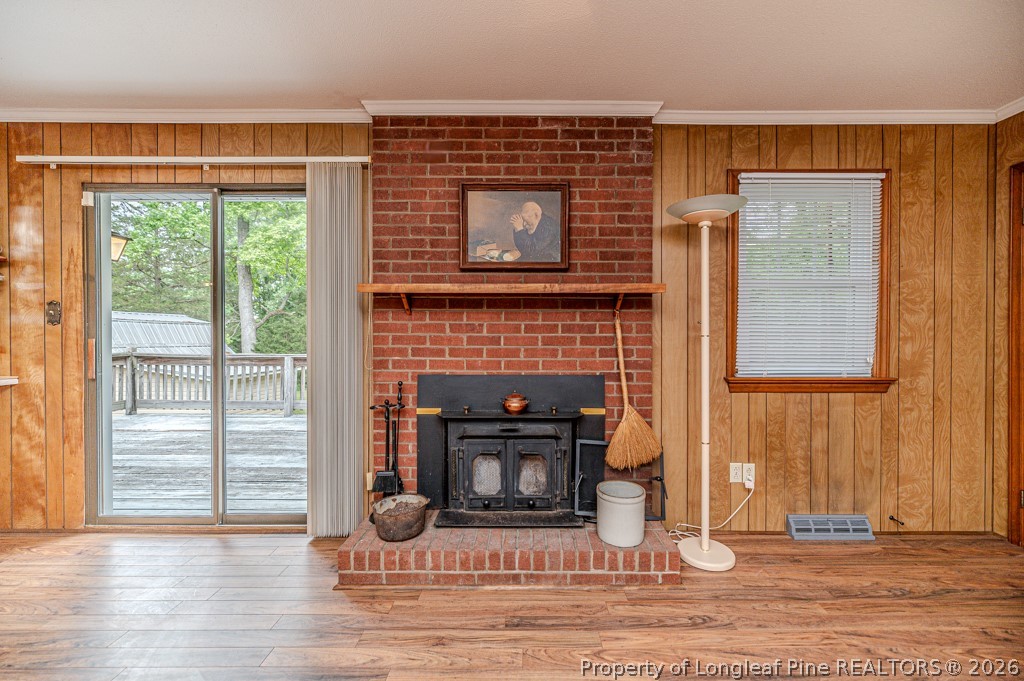 3384 Goldston Glendon Road Goldston, NC 27252 - Photo 10 of 47 a living room with a fireplace and a floor to ceiling window