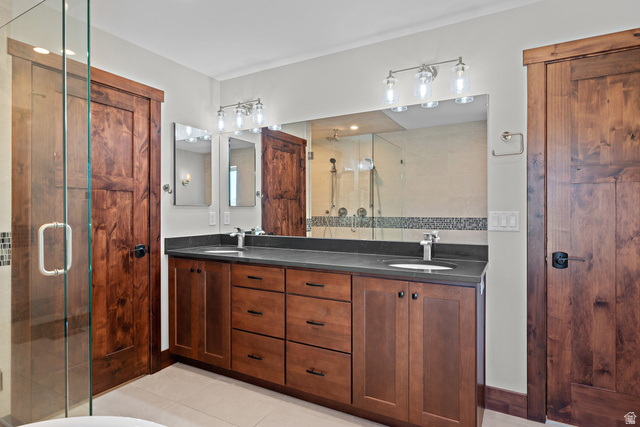 4221 Juniper Circle Alpine, UT 84004 - Photo 16 of 66 Bathroom featuring a dual vanity with a dark countertop, undermount sinks, and contemporary faucets